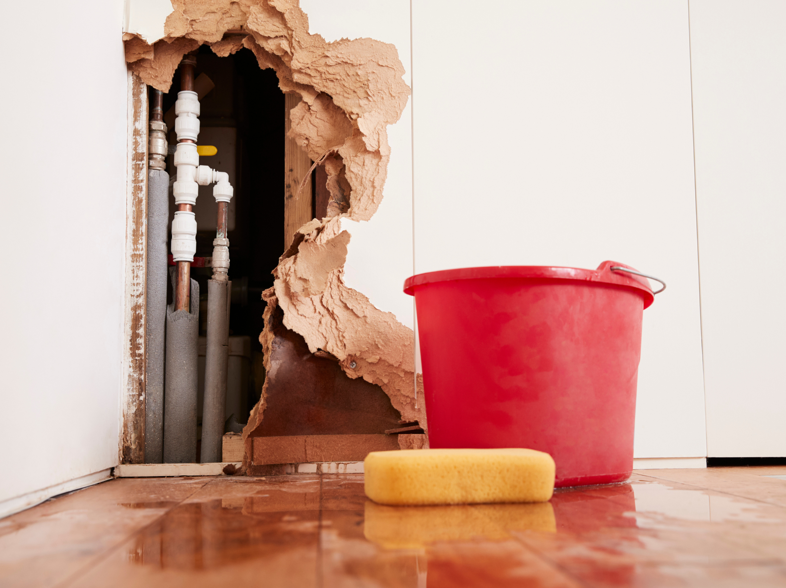Water leaking through a wall showing storm moisture damage spreading inside a home