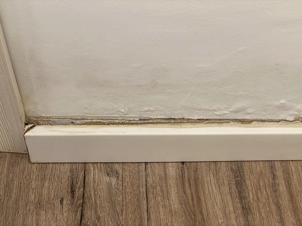 Warped baseboard caused by hidden water damage
