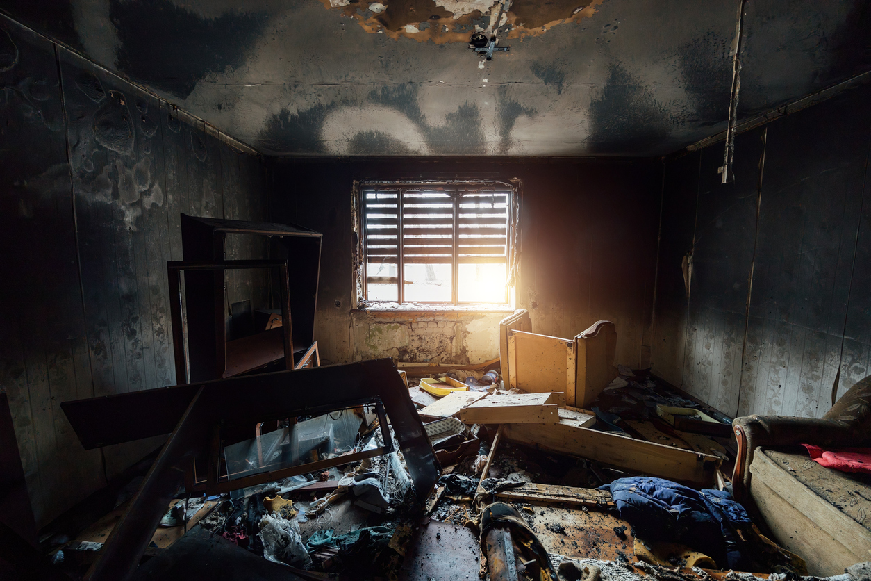Black soot residue staining the walls of a fire-damaged home