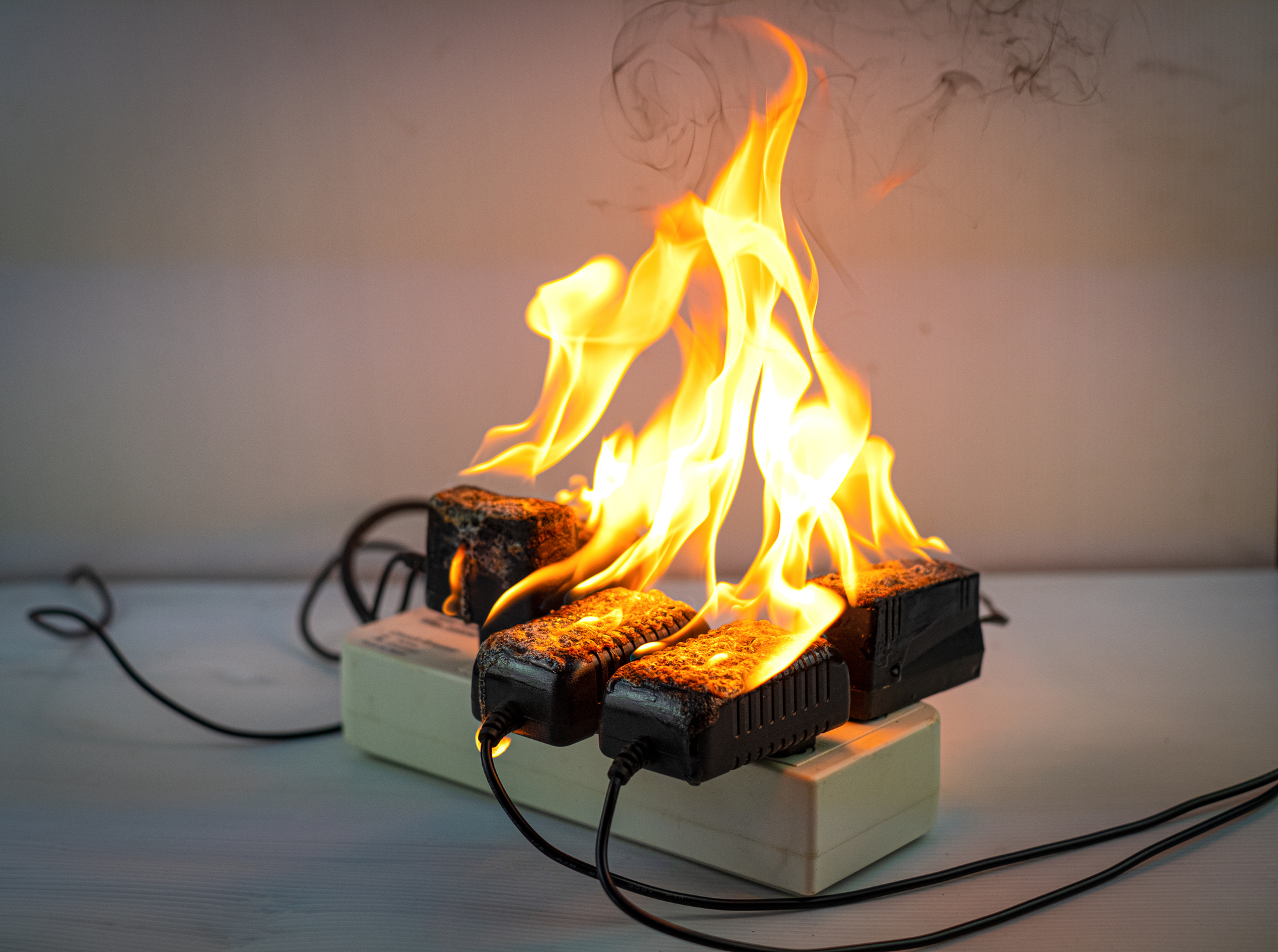 Power strip and plug adapters on fire from an electrical overload